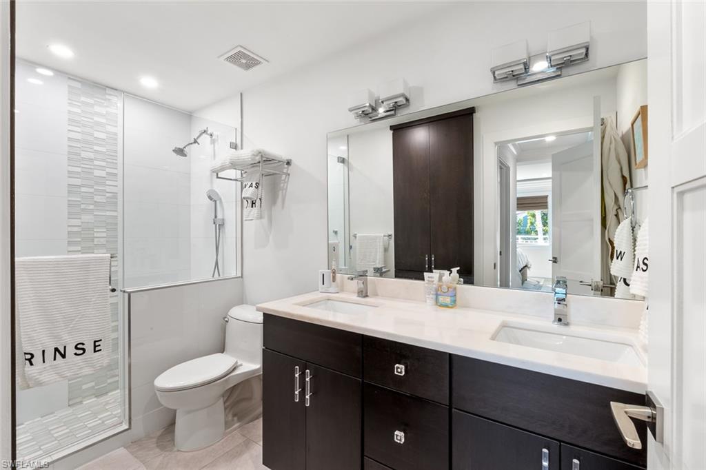 320 14th Avenue South, Unit 320B Naples, FL 34102 - Photo 11 of 14 a bathroom with a sink vanity toilet and shower