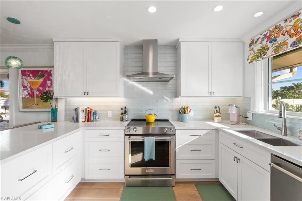 320 14th Avenue South, Unit 320B Naples, FL 34102 - Photo 4 of 14 a kitchen with granite countertop white cabinets and white appliances