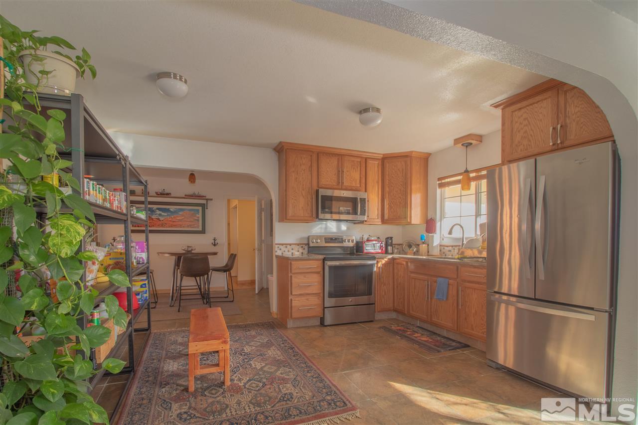 1301 Roberts Street Reno, NV 89502 - Photo 11 of 18 a kitchen with stainless steel appliances granite countertop a refrigerator a stove top oven a sink and dishwasher