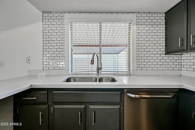 a kitchen with a sink and a window