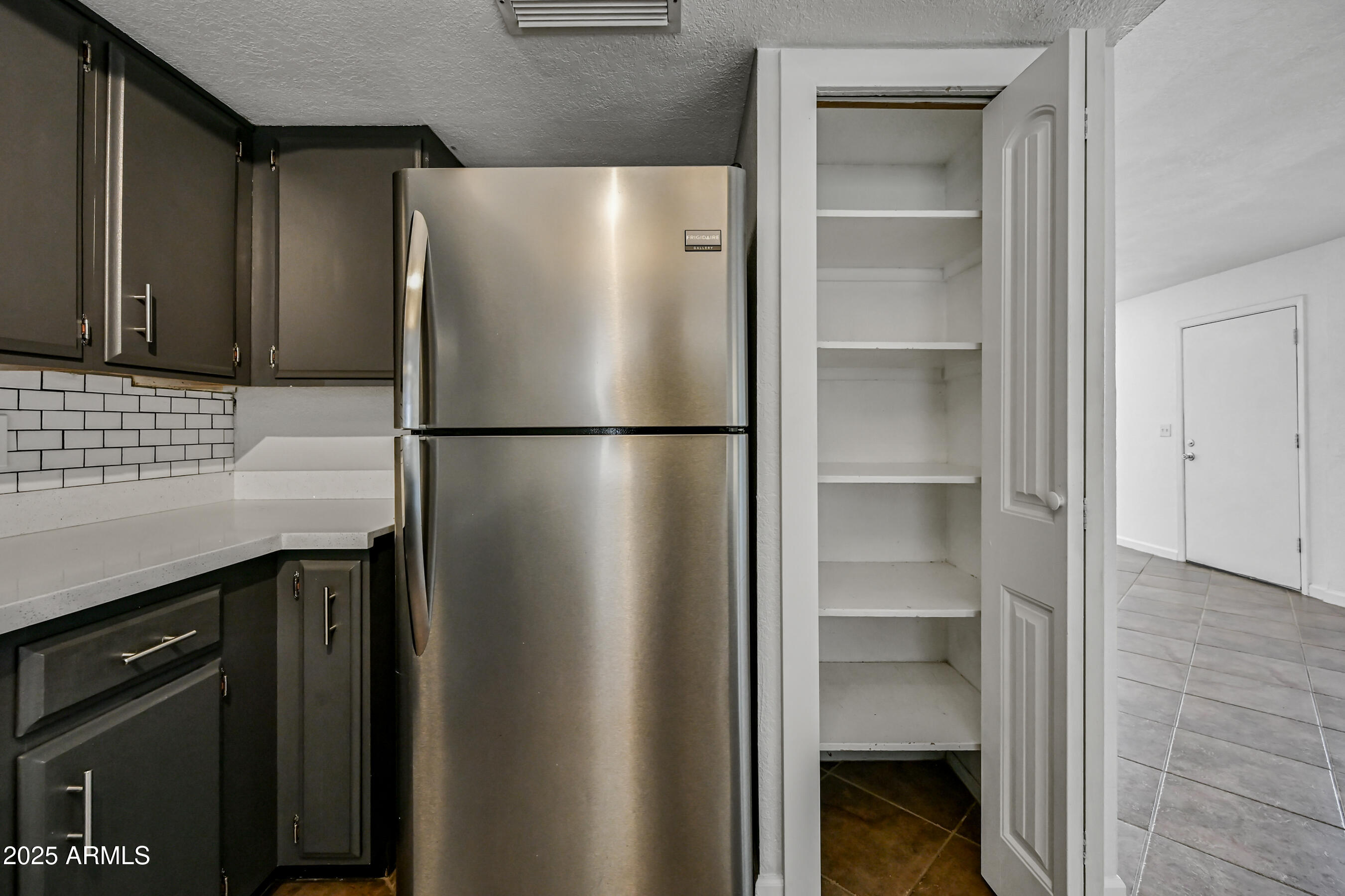 5558 West Cortez Street Glendale, AZ 85304 - Photo 14 of 34 a white refrigerator freezer and a stove sitting inside of a kitchen
