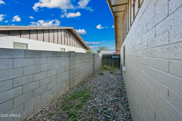 a view of backyard with wooden fence