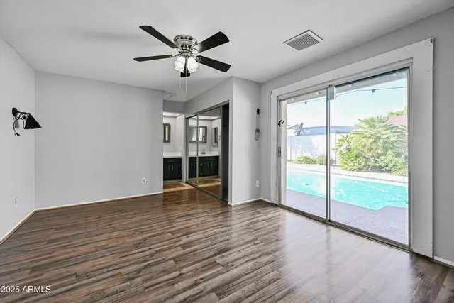 a view of empty room with wooden floor