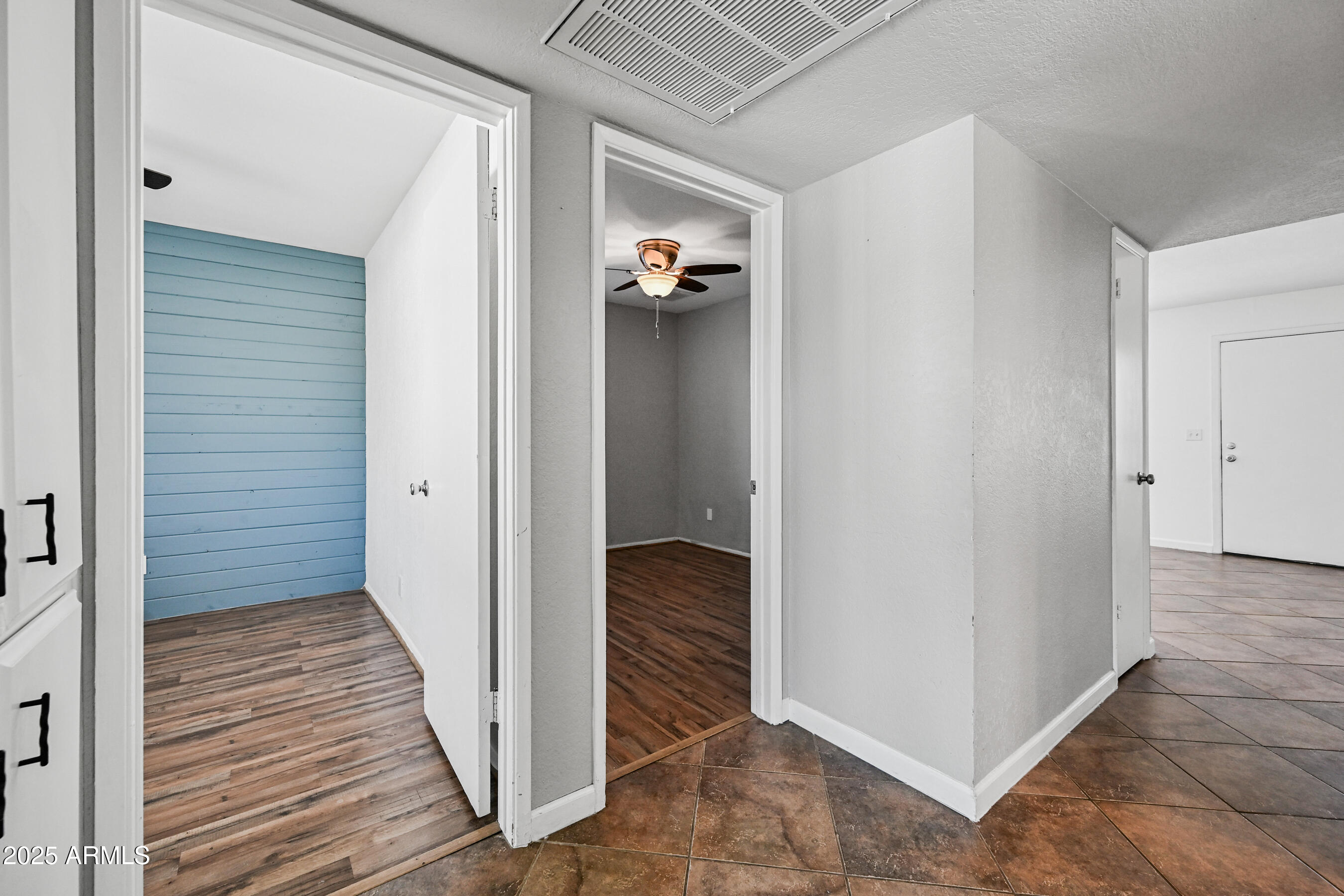 5558 West Cortez Street Glendale, AZ 85304 - Photo 27 of 34 a view of a hallway with closet and wooden floor