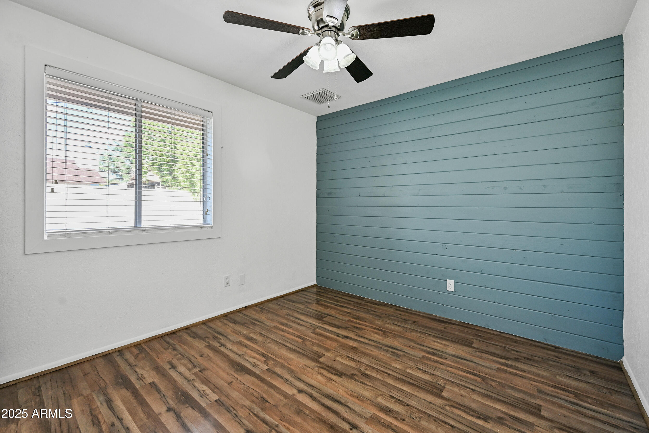 5558 West Cortez Street Glendale, AZ 85304 - Photo 28 of 34 a view of an empty room with wooden floor and a window