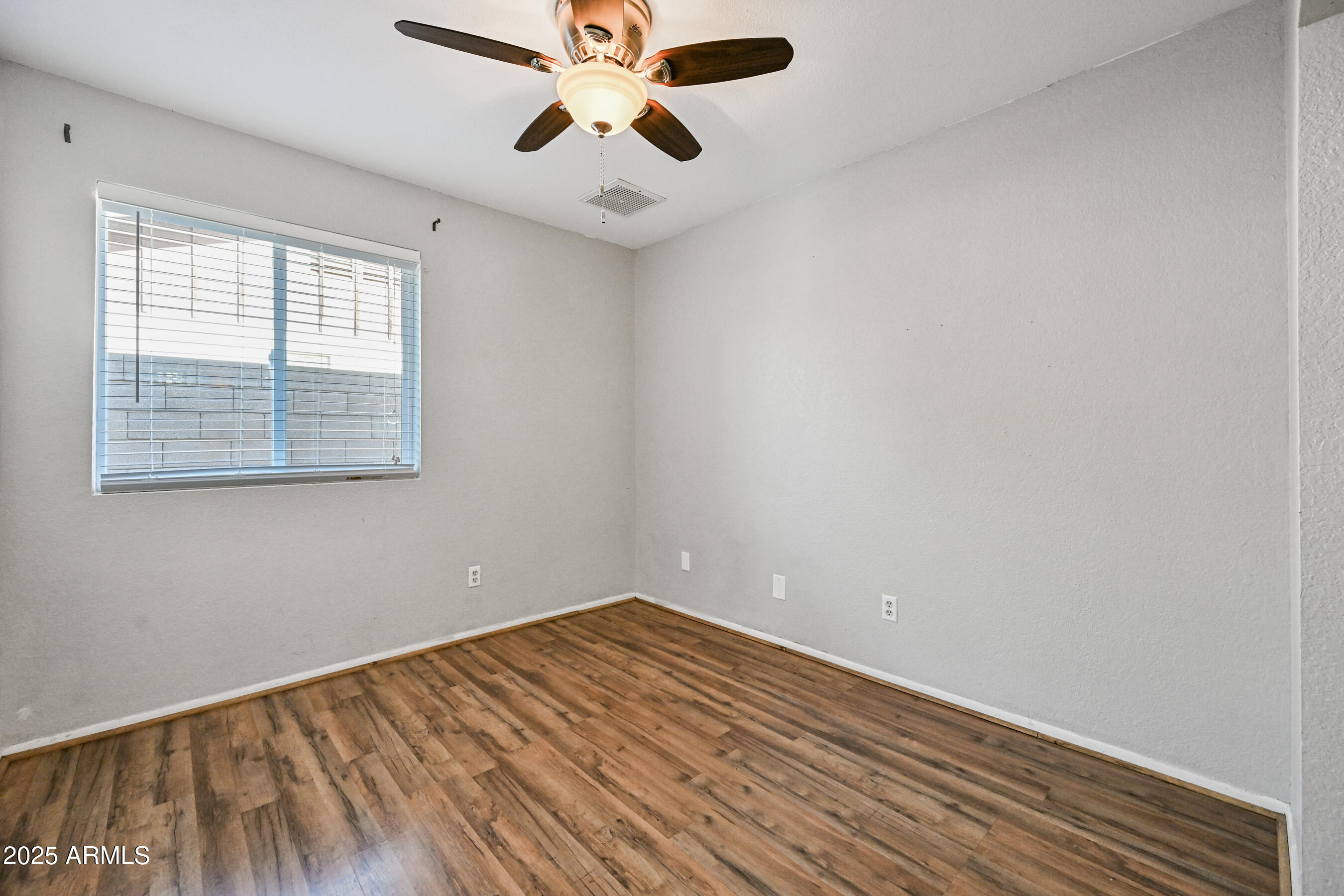 5558 West Cortez Street Glendale, AZ 85304 - Photo 29 of 34 an empty room with a window and a ceiling fan