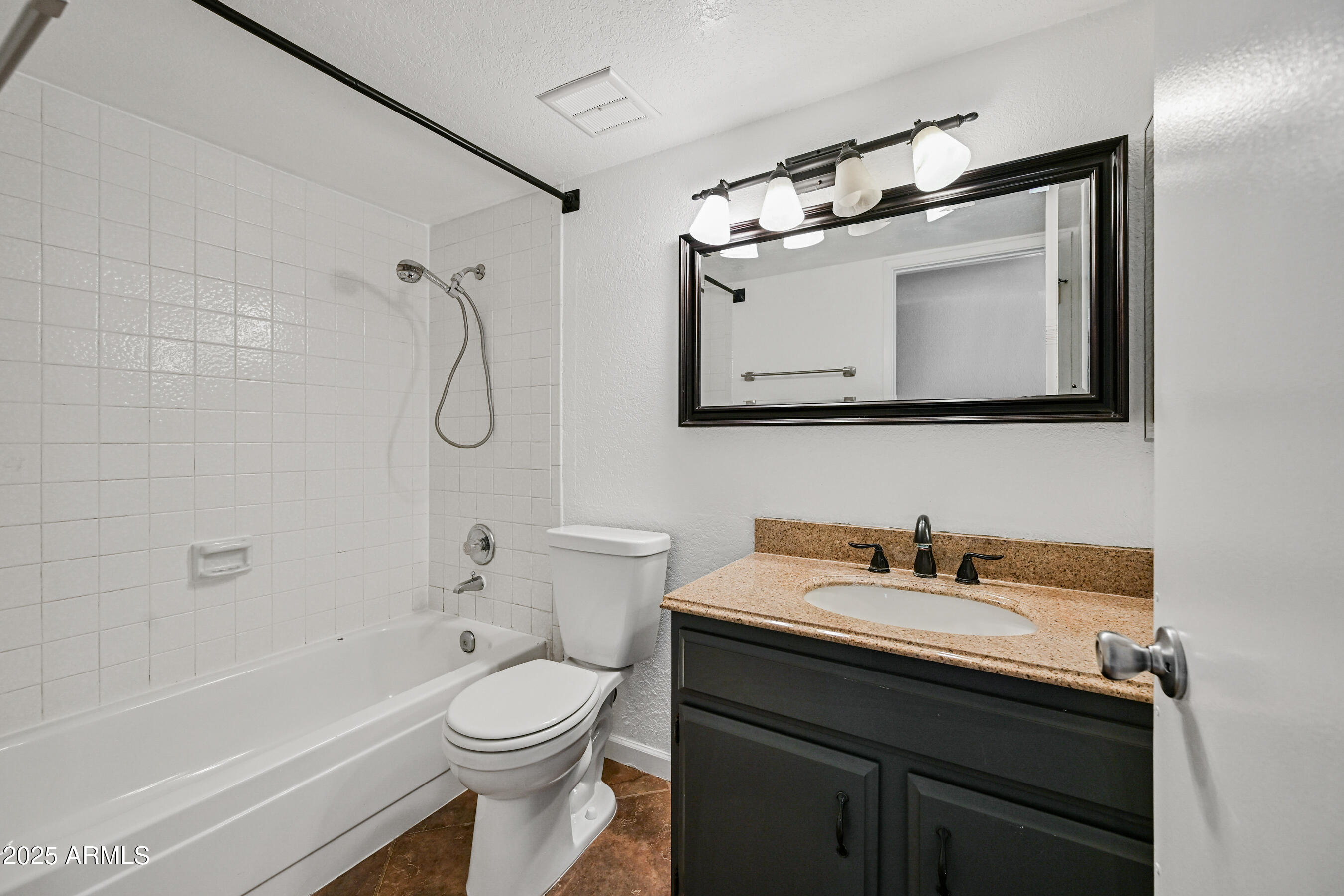 5558 West Cortez Street Glendale, AZ 85304 - Photo 30 of 34 a bathroom with a sink a toilet and a bathtub