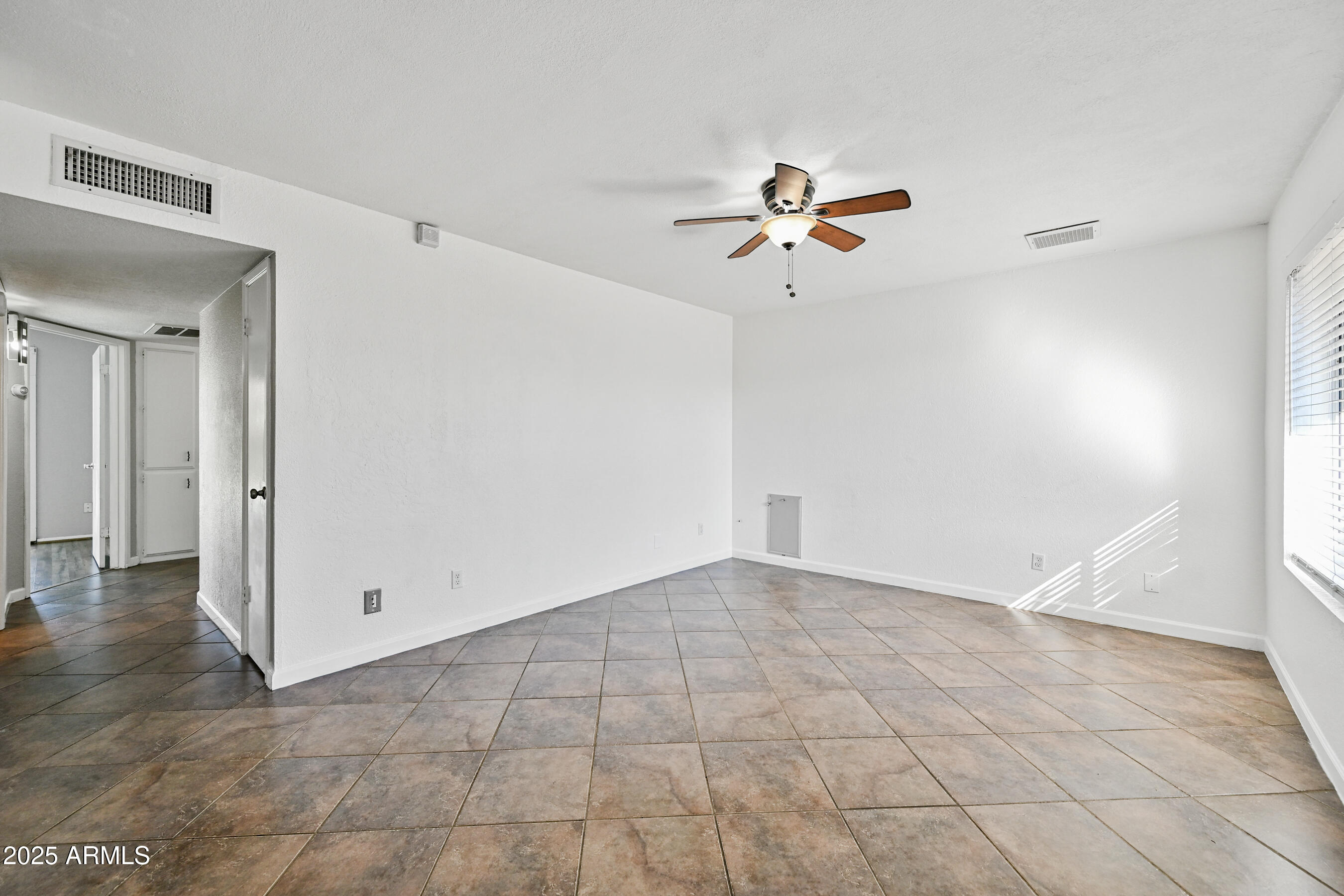 5558 West Cortez Street Glendale, AZ 85304 - Photo 3 of 34 wooden floor in an empty room with a window