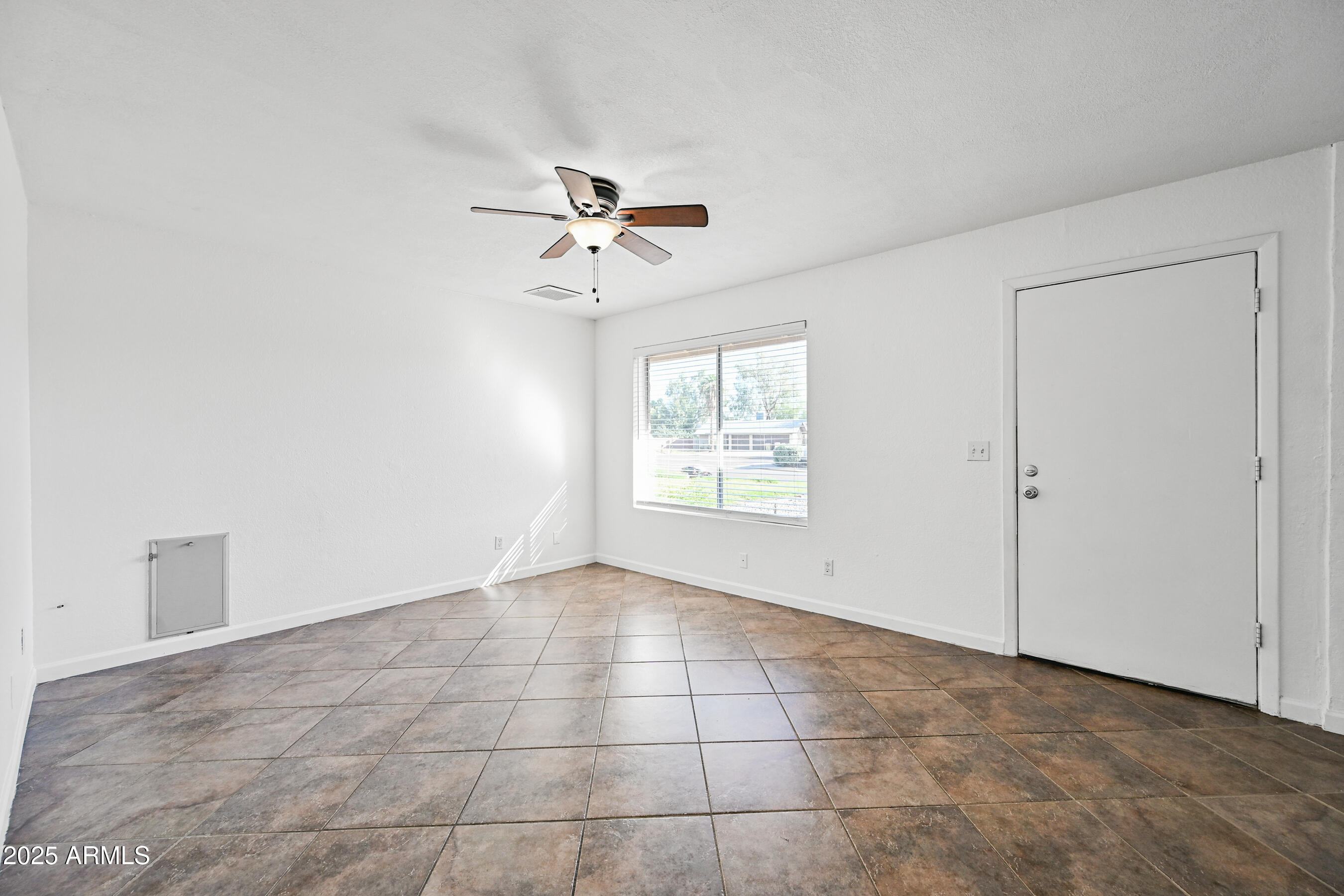 5558 West Cortez Street Glendale, AZ 85304 - Photo 4 of 34 a view of an empty room with a window