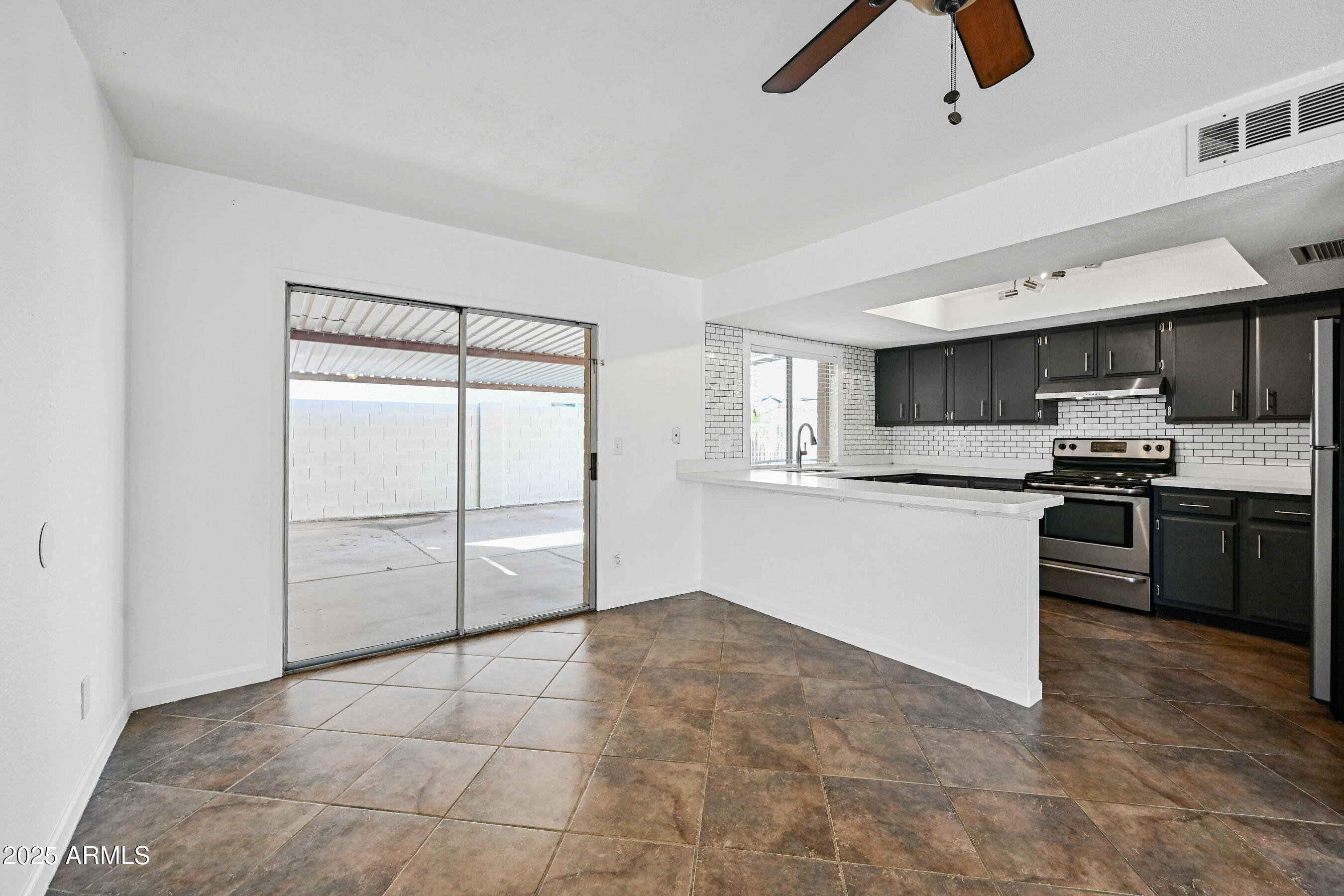 5558 West Cortez Street Glendale, AZ 85304 - Photo 7 of 34 a kitchen with stainless steel appliances a refrigerator and microwave