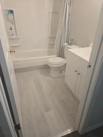 a bathroom with a toilet a sink and mirror