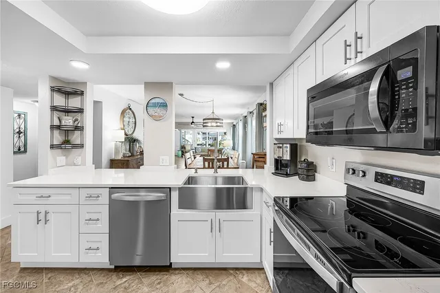 a kitchen with stainless steel appliances a stove microwave and cabinets