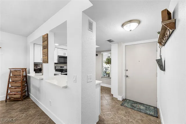 a view of a kitchen with furniture and wooden floor