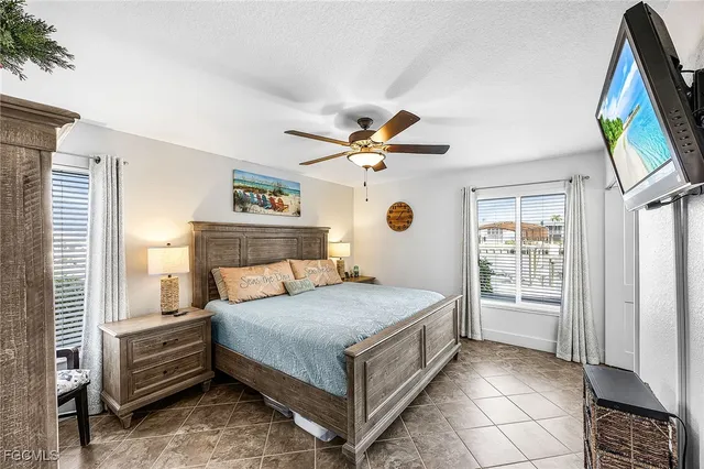 a bedroom with a bed and a painting on the wall