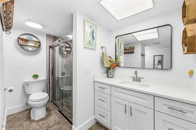 a spacious bathroom with a toilet a sink and a mirror