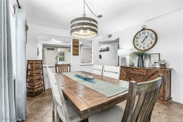 a living room with furniture a clock and a clock