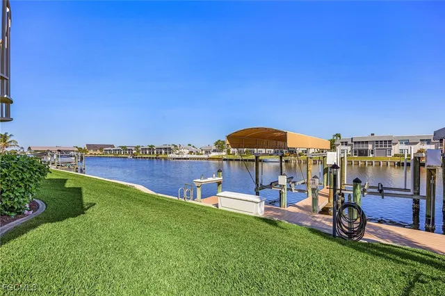 a view of a swimming pool with a bench and lawn chairs