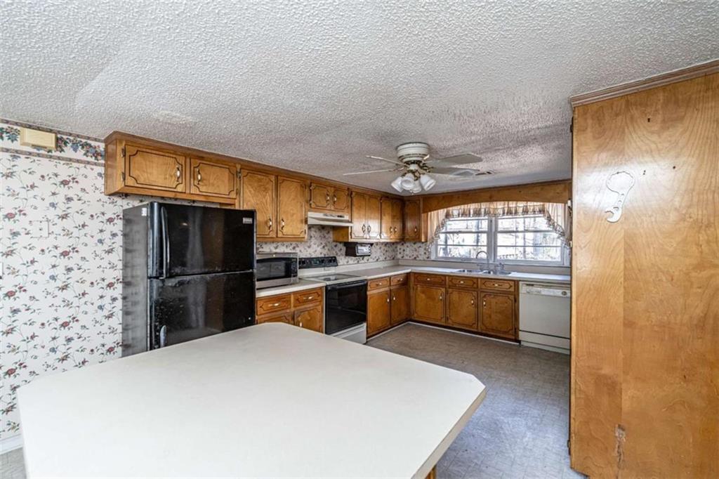 4383 Martha Berry Highway Rome, GA 30165 - Photo 8 of 27 a kitchen with a refrigerator and a sink