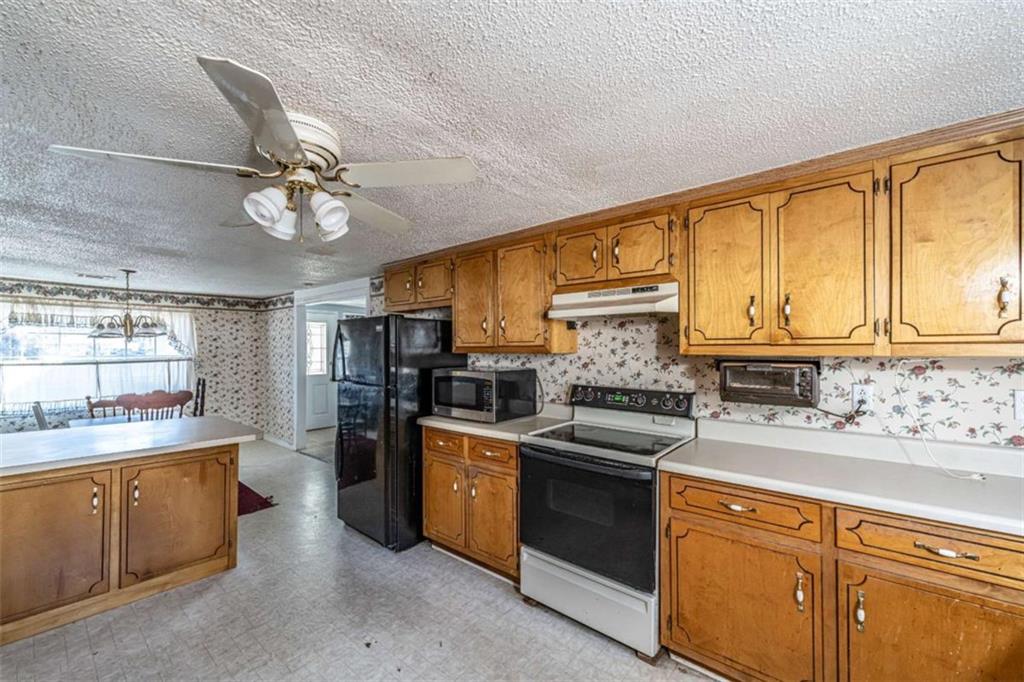4383 Martha Berry Highway Rome, GA 30165 - Photo 10 of 27 a kitchen with stainless steel appliances granite countertop a sink and cabinets
