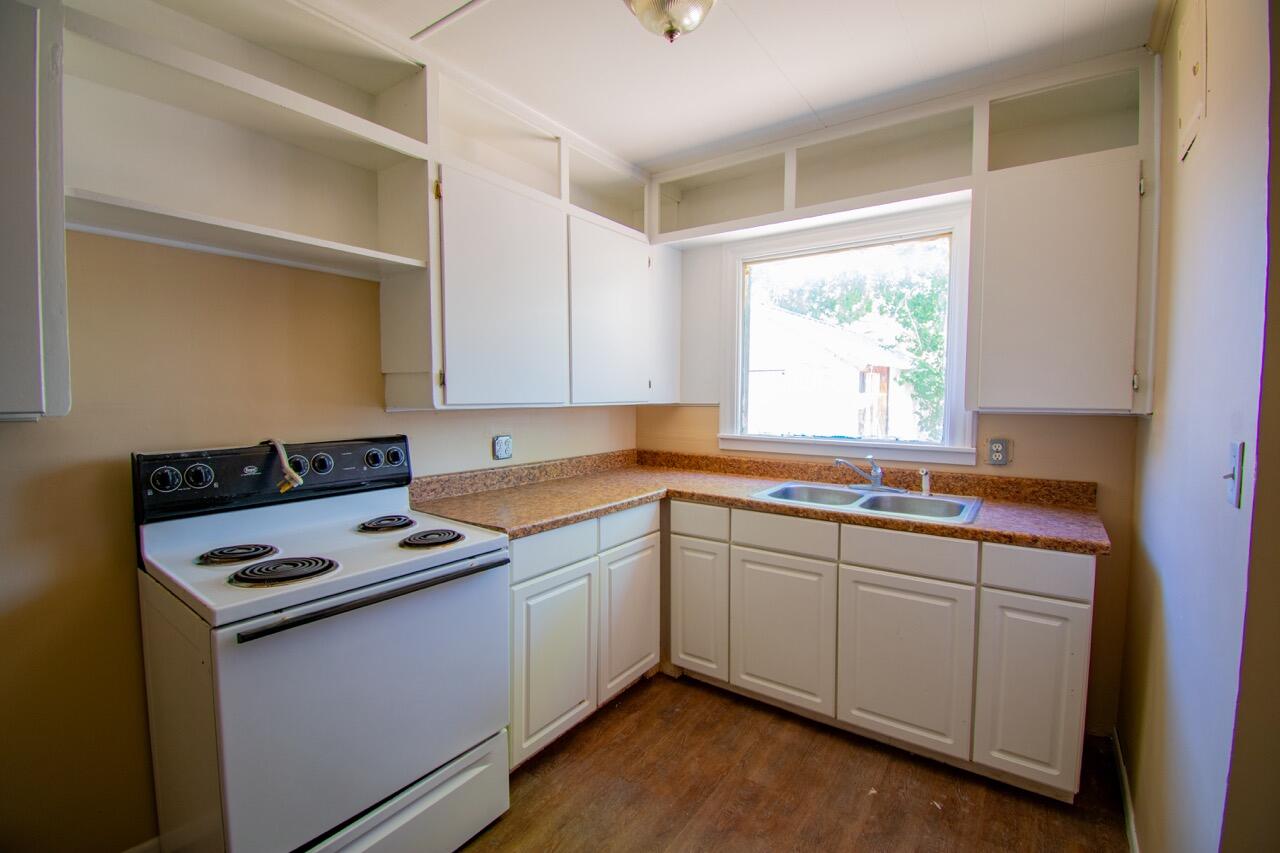 2424 27th Street Lubbock, TX 79411 - Photo 6 of 14 a kitchen that has a sink and a stove in it