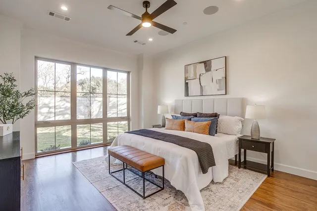 a spacious bathroom with a tub sink and mirror