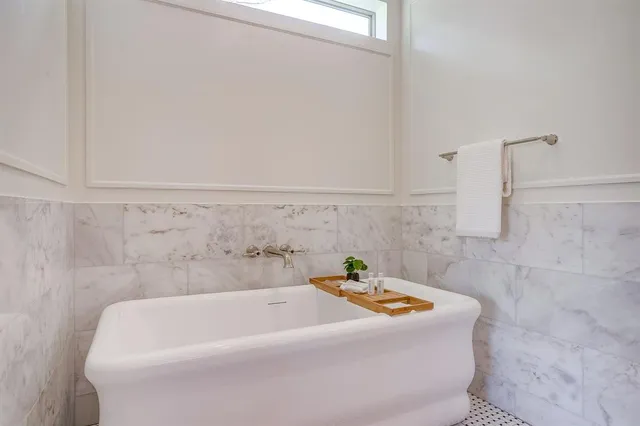 a bathroom with a double vanity sink and a mirror