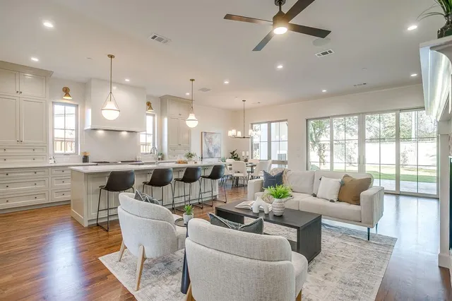 a living room with lots of furniture and a large window