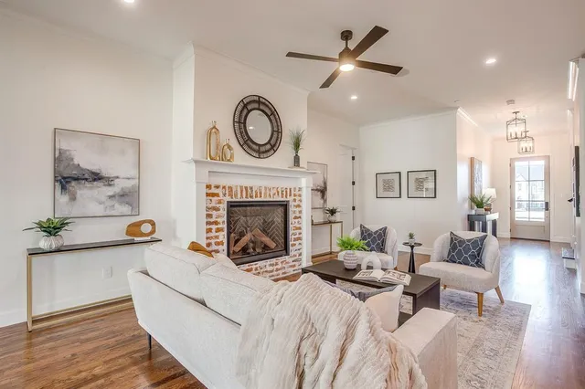 a living room with furniture a clock and a fireplace