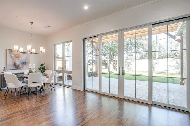 a living room with furniture kitchen view and a wooden floor