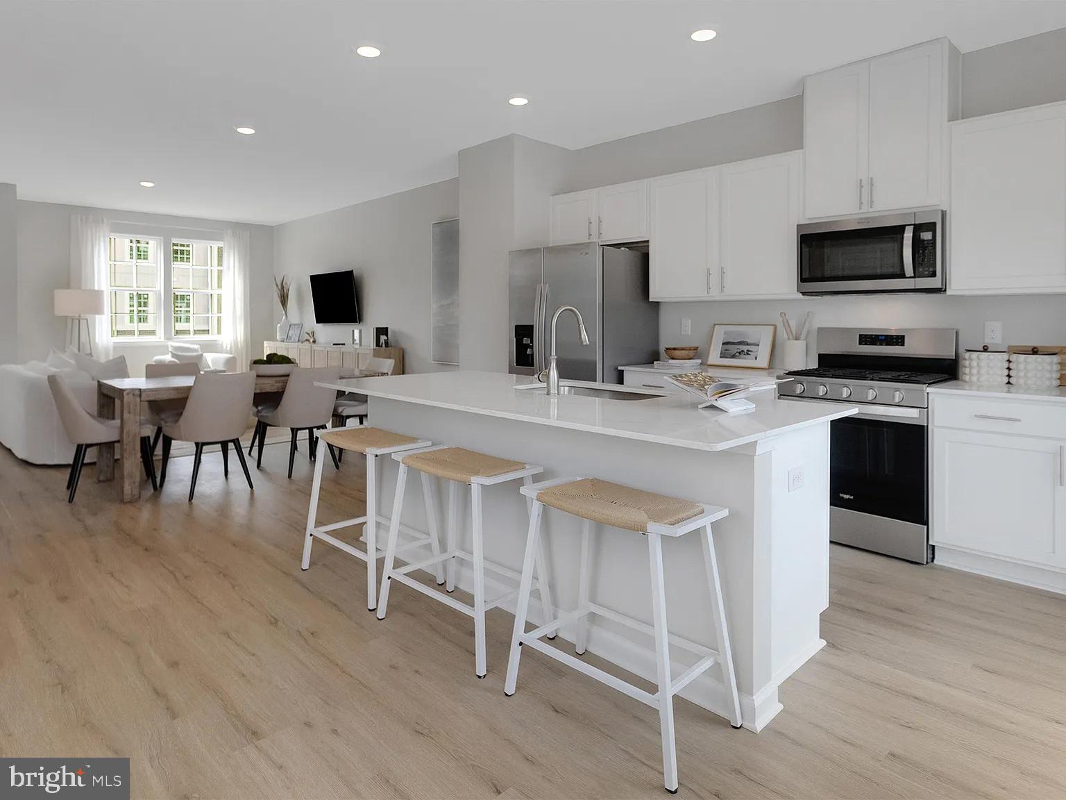 171 Sandy Rdg Road Sicklerville, NJ 08081 - Photo 1 of 13 a kitchen with stainless steel appliances granite countertop a stove a sink a microwave a refrigerator a dining table and chairs with wooden floor