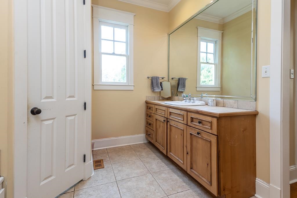 1915 Teague Store Road Somerville, TN 38068 - Photo 29 of 38 Wood-finish vanity with an integrated sink and light-toned countertop, featuring a large wall-mounted mirror