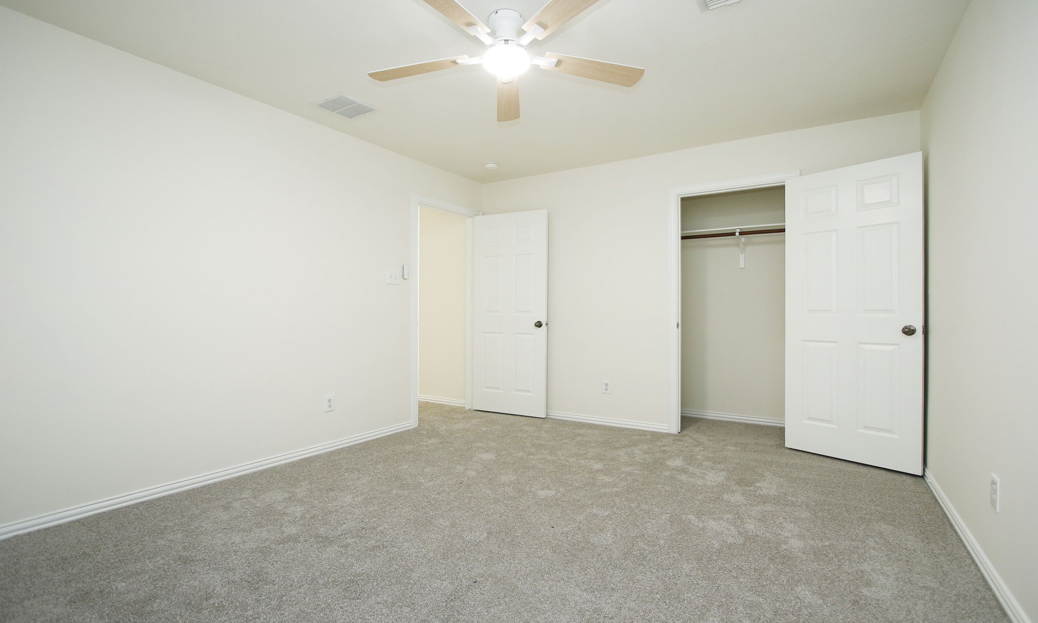 1210 Berwick Manor Court Spring, TX 77379 - Photo 36 of 50 an empty room with closet and a chandelier fan