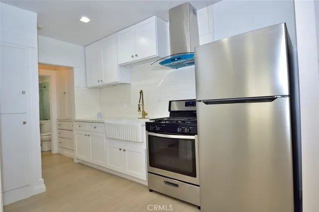 a white refrigerator freezer and a stove in a kitchen