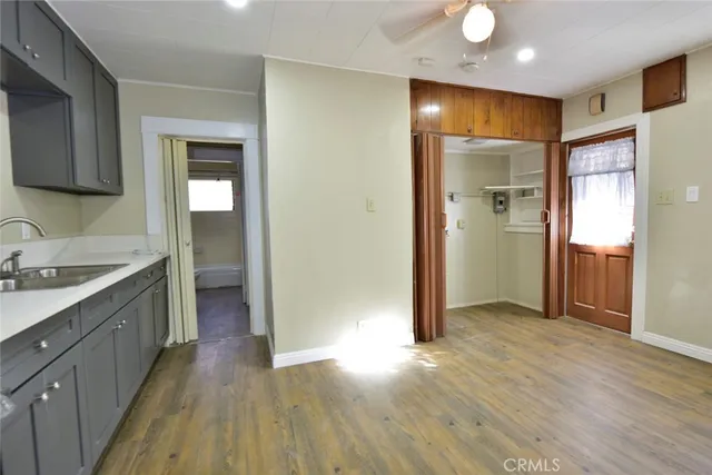 a view of a kitchen cabinets a sink and wooden floor
