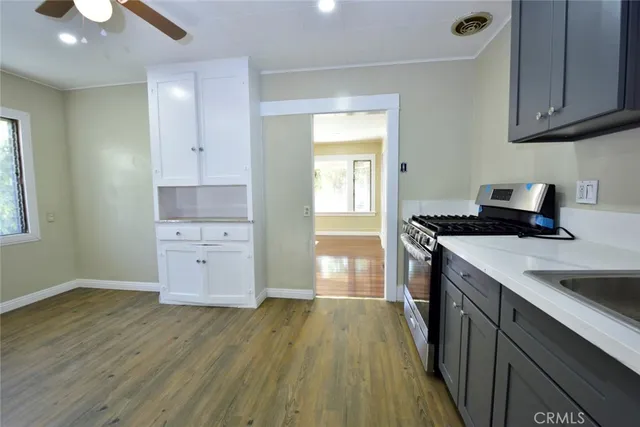 a kitchen with a sink and wooden floor