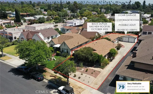 an aerial view of a house with a garden and mountain view in back