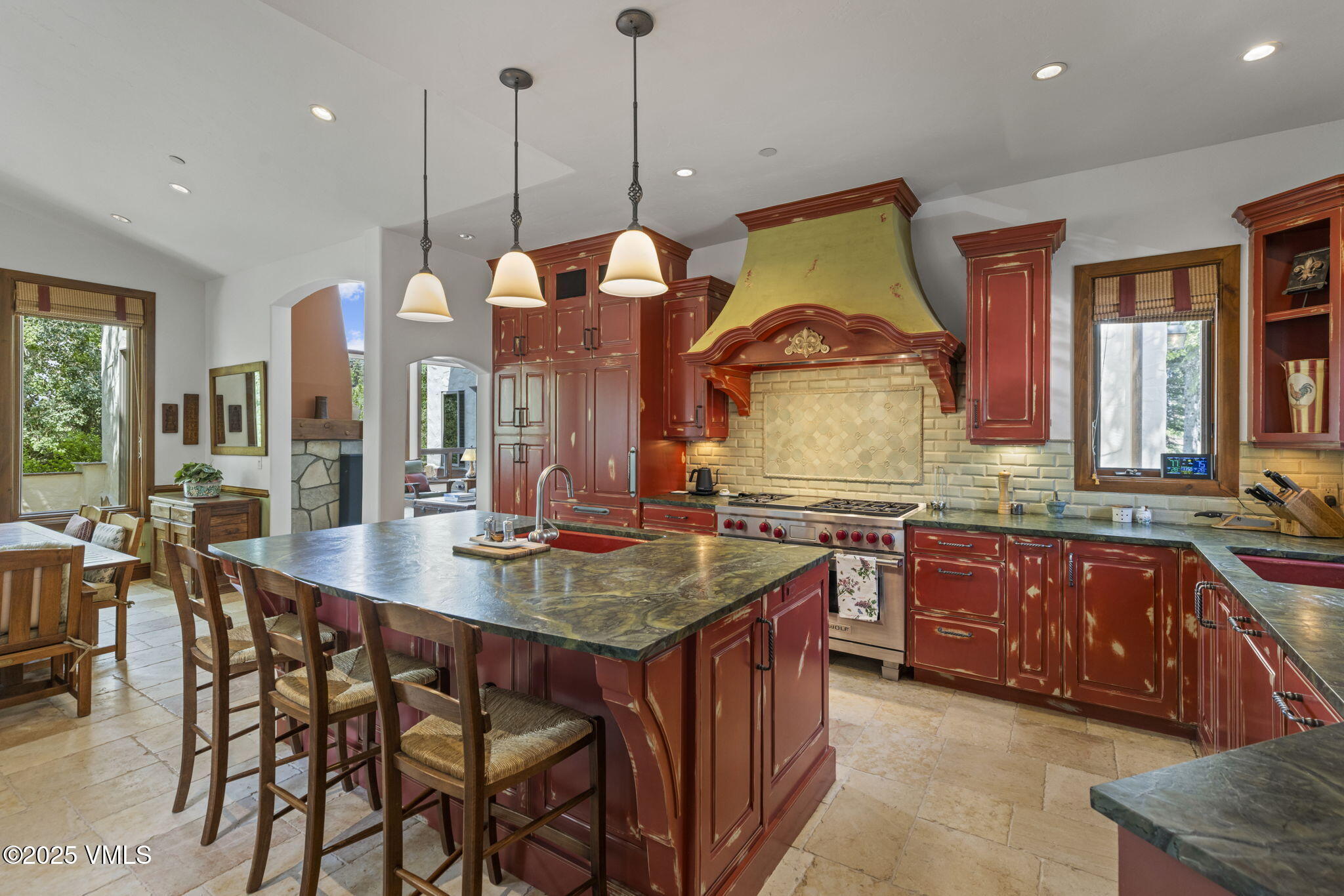 225 Alcazar Drive Edwards, CO 81632 - Photo 12 of 39 a kitchen with granite countertop a stove a sink a dining table and chairs