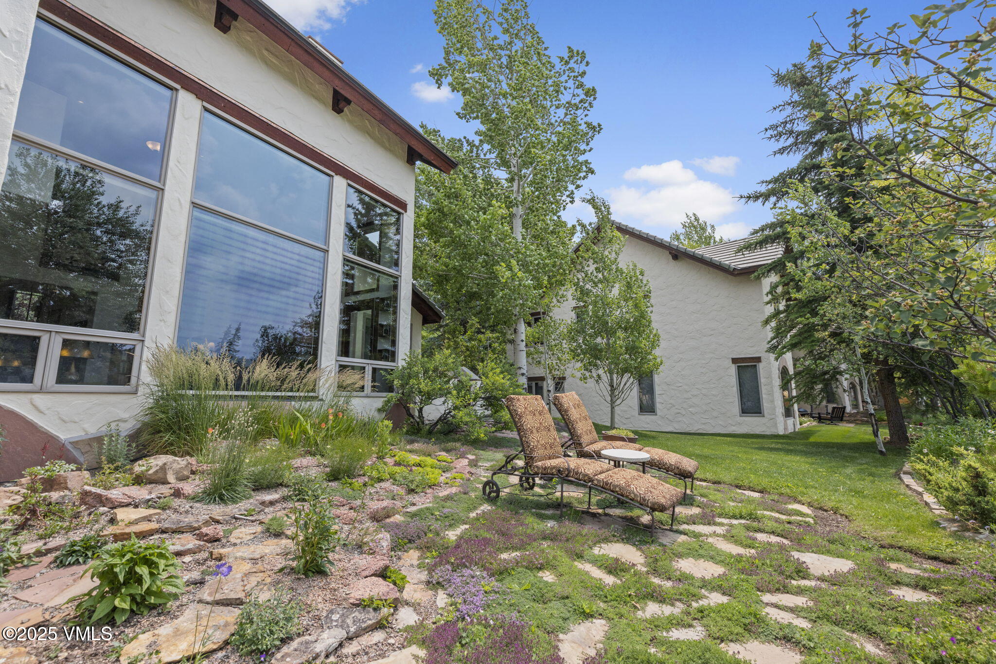 225 Alcazar Drive Edwards, CO 81632 - Photo 19 of 39 a view of a chair and table in the backyard