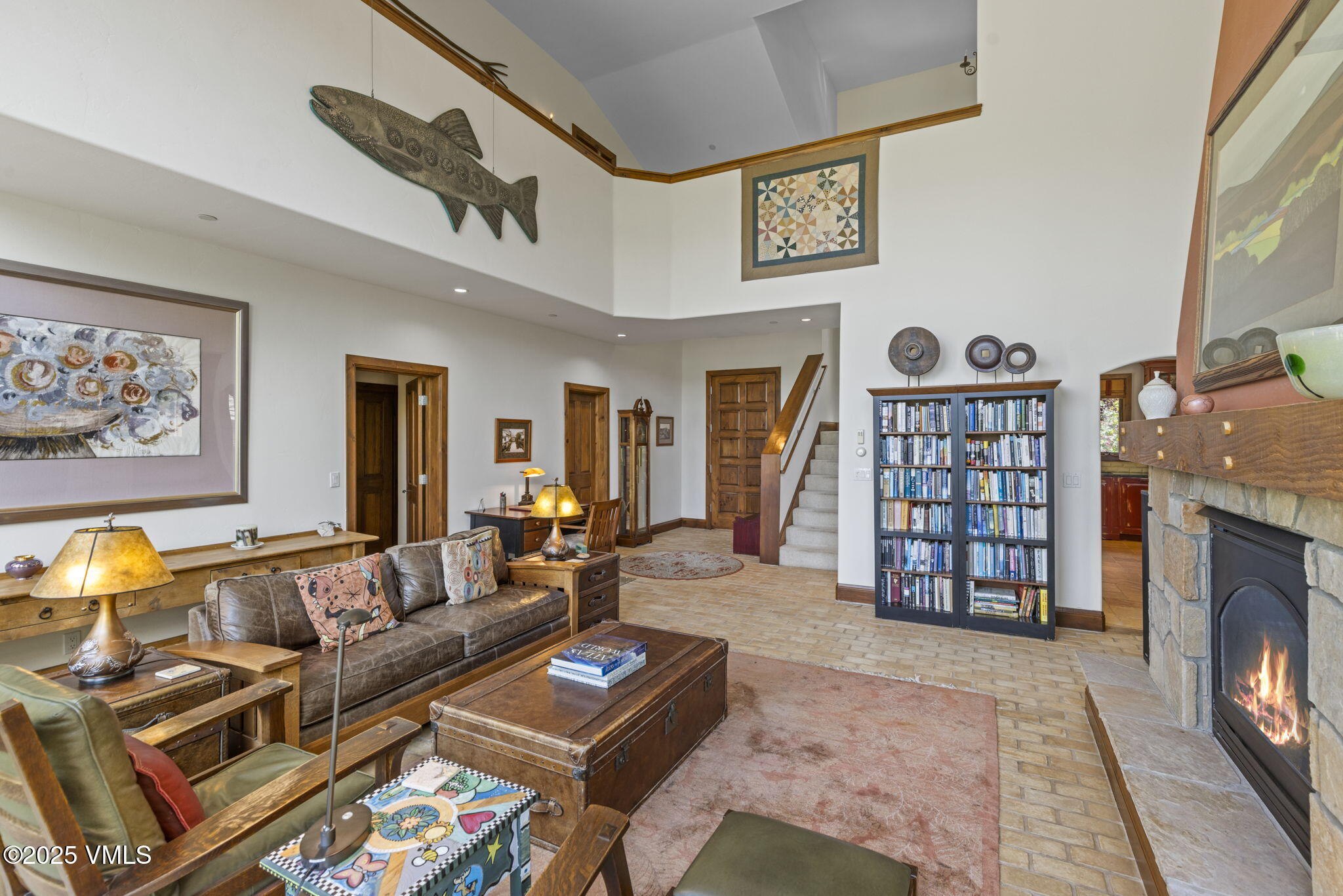 225 Alcazar Drive Edwards, CO 81632 - Photo 3 of 39 a living room with furniture a flat screen tv and a fireplace