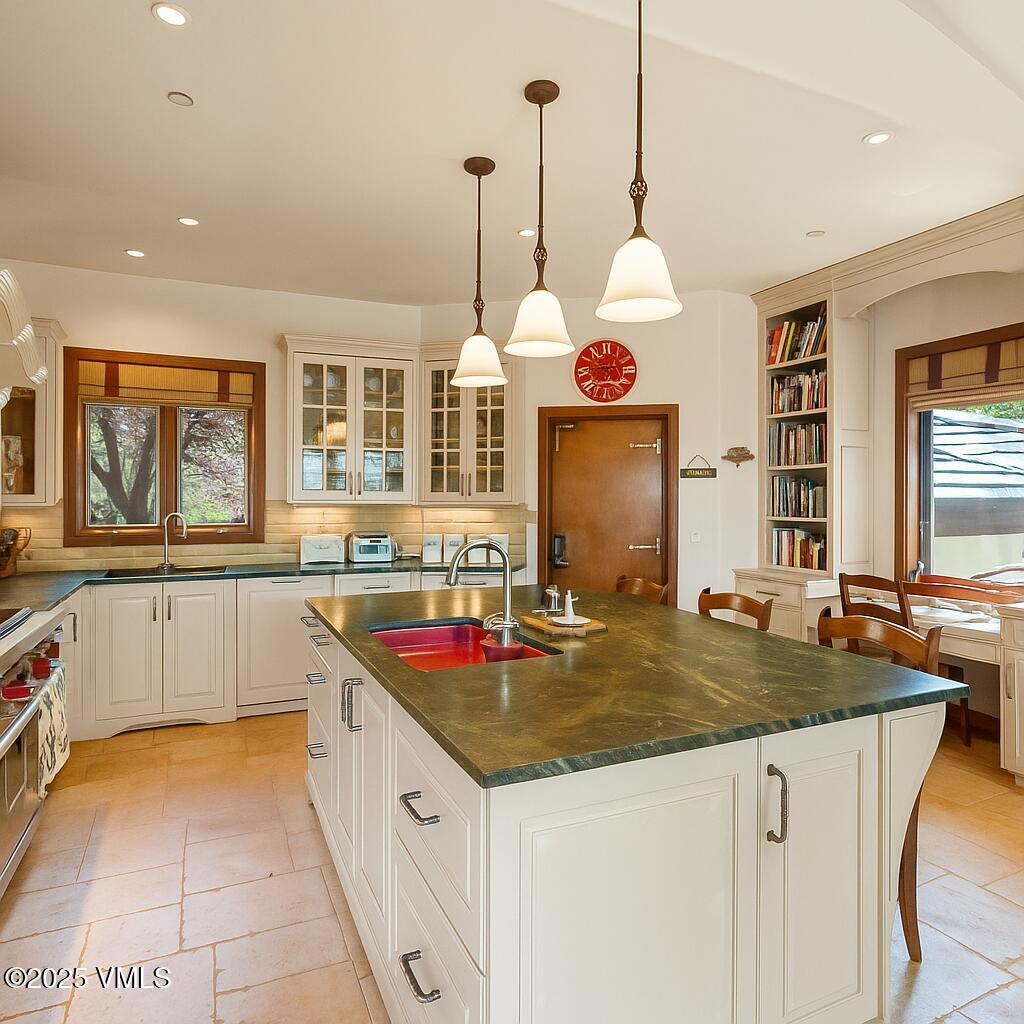 225 Alcazar Drive Edwards, CO 81632 - Photo 8 of 39 a kitchen with granite countertop a sink and white cabinets