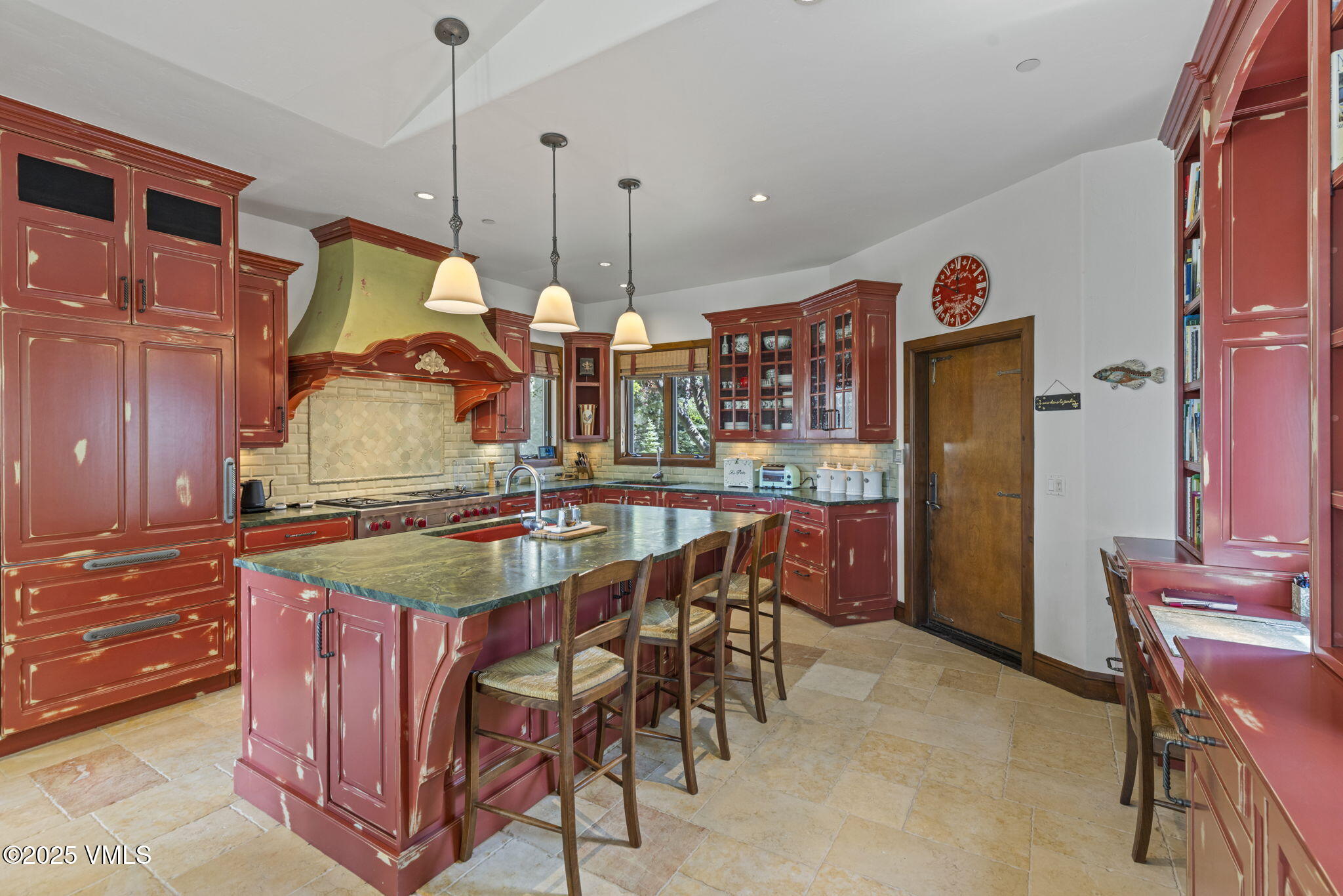 225 Alcazar Drive Edwards, CO 81632 - Photo 9 of 39 a kitchen with stainless steel appliances granite countertop a table chairs and a refrigerator