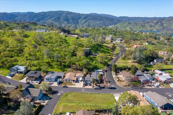 a view of a house with a mountain and a yard