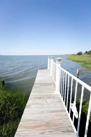 a kitchen with stainless steel appliances granite countertop a lot of counter space and wooden floors