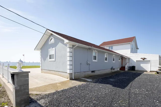 a dining room with furniture a chandelier and wooden floor