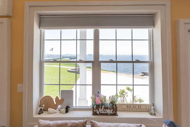 a dining hall with stainless steel appliances granite countertop a stove top oven a dining table and chairs