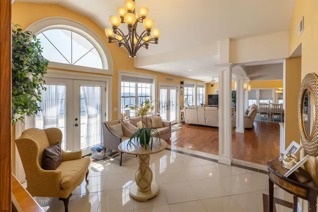 a view of a hallway with wooden floor and stairs