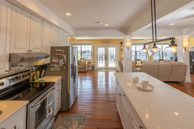 a bedroom with a bed and a flat tv screen on dresser