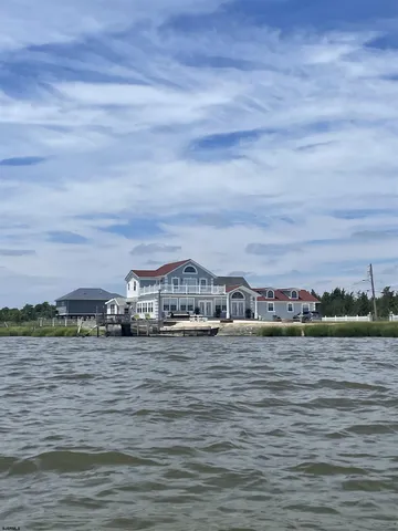 a view of a lake with houses in the background
