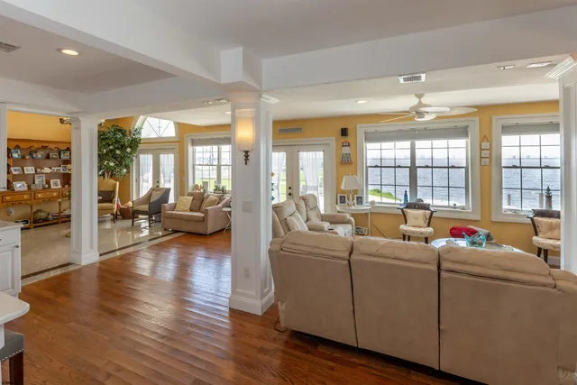 a bed sitting in a spacious bedroom next to a window