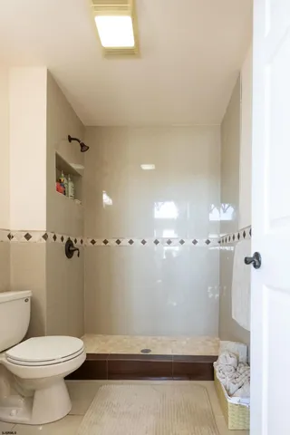 a bathroom with a sink toilet and mirror